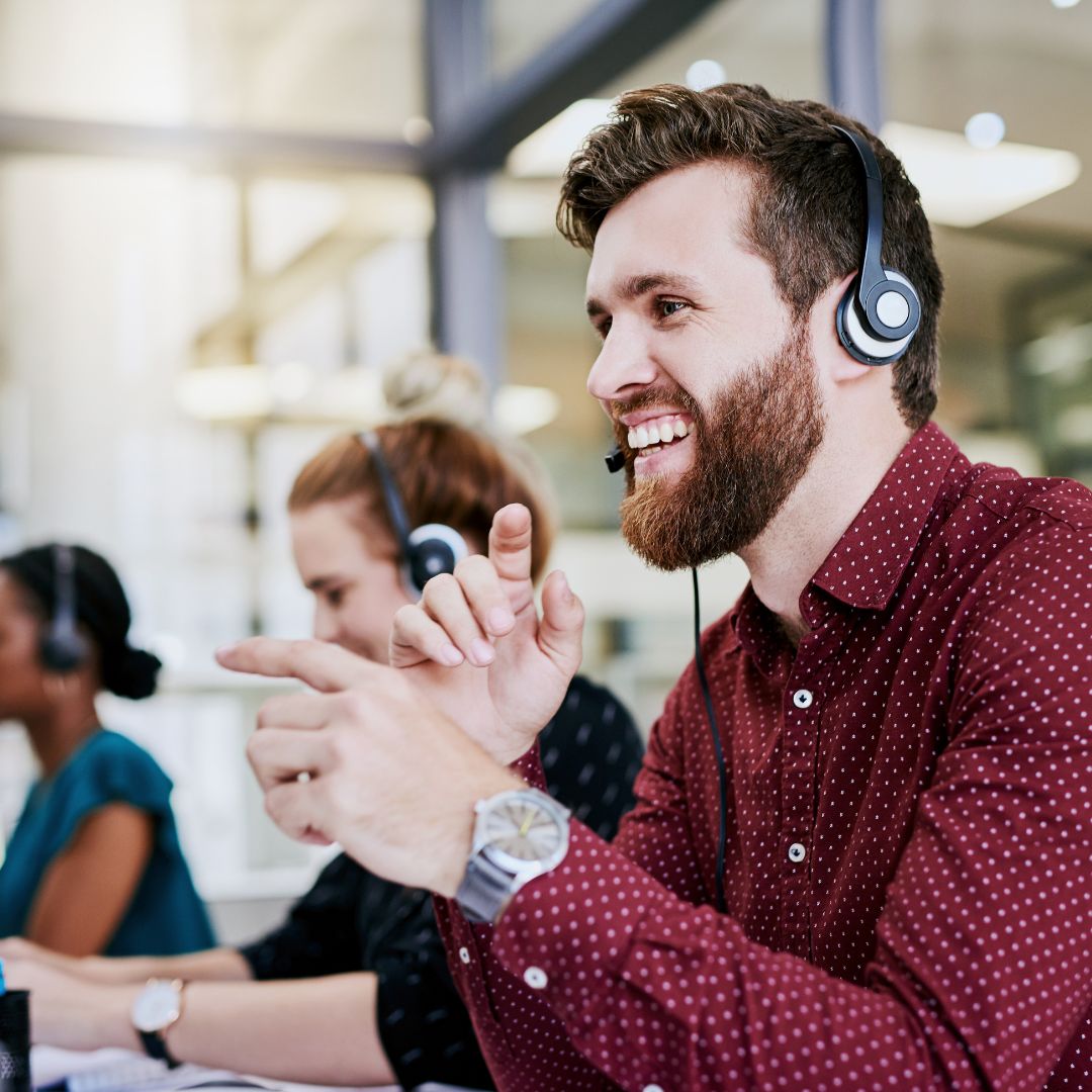 man smiling with a headset on